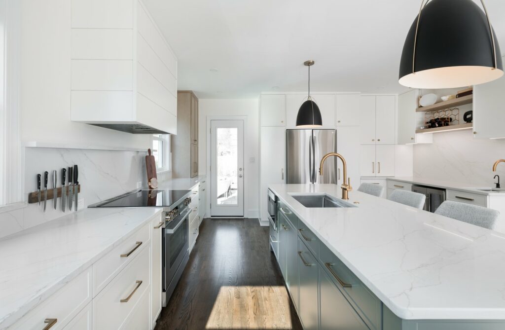 Modern kitchen remodel featuring a white theme design with sleek cabinetry, a spacious countertop, and a minimalist layout.